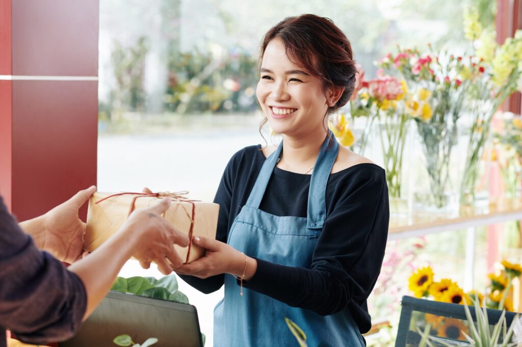 Florist giving gift box to client